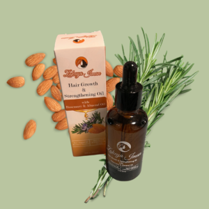 Amber colored oil bottle with almonds and rosemary herb.